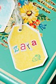 Letters stuck onto hand-crafted gift tag with printed bunny motif