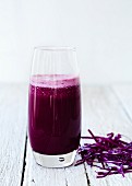 A glass of red cabbage & apple juice