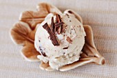 A scoop of home-made stracciatella ice cream with grated chocolate