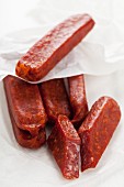 Landjäger (smoked cured speciality sausage made from beef and pork), whole and cut into pieces