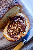 A brioche filled with chocolate spread and chopped hazelnuts