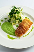 Fried sea bass fillet with pea purée and a side salad