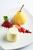 Vanilla posset with berries and a poached pear