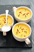 Creamy squash soup with curry and red peppercorns