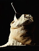 A sack of flour against a black background