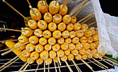 Skewered corn cobs, cooked and stacked