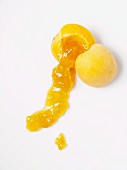 A halved apricot with apricot jam