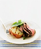 Slices of roast beef with barbecued potato