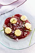 Beetroot carpaccio with edible flowers