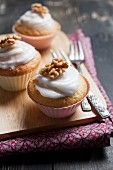 Muffins with glacé icing and walnuts