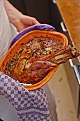 Pot-roasted lamb shoulder in a clay dish