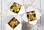Salmon with spinach and saffron potatoes in takeaway containers