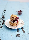 A profiterole with caramelised plums and amaretto