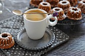 A cup of espresso with mini Bundt cakes