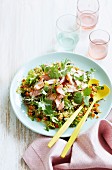Quinoa salad with salmon, lettuce leaves, carrots and raisins