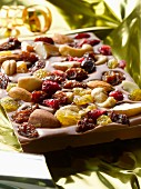 A slab of chocolate with dried fruits and nuts