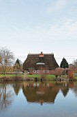 Thatched residential house on a lake (Germany)