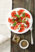 Tomatoes with mozzarella, basil and capers