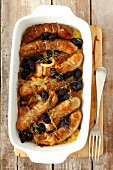 Sausages baked with onions and prunes
