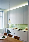 Modern kitchen with white cupboards and indirect lighting