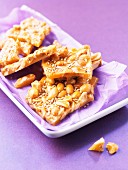 Caramel pralines wit nuts and sesame on plate