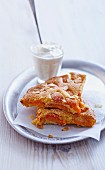 Apricot tart with flaked almonds and cream