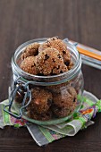 Apricot ginger bites with cocoa nibs in glass jar