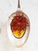 Saffron threads in oil on a spoon