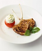 Grilled pork chops with a stuffed tomato