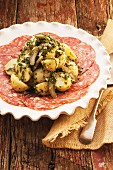 Potato salad with herb dressing, served on slices of salami