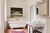 A traditional tomette tiled floor in white bathroom with artwork by Martini Maggi