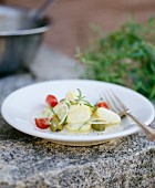 Potato salad with olives, rocket and tomatoes