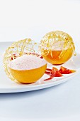Blood oranges filled with a dessert made of blood orange juice, cream and sugar, topped with a caramel lattice