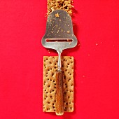 A cheese slicer on a piece of crispbread (view from above)