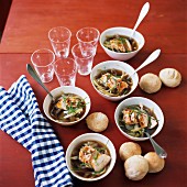 Chicken & noodle soup in bowls, served with bread rolls