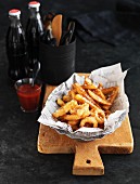 Deep-fried squid rings and chips on newspaper
