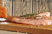 Raw chicken breast with spices and rosemary