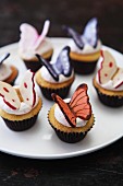 Vanilla cupcakes with cream icing and chocolate butterflies