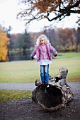 Girl balancing on log