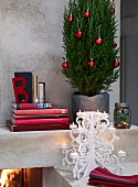 Christmas tree beside stack of books