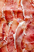 Several slices of Prosciutto from Sardinia (filling the image)