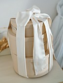 Three round gift boxes tied together with chiffon ribbon