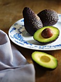 Whole and halved avocado