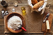 Verschiedene Zutaten für die Herstellung von Brot - Mehl, Hefe, Öl, Butter, Salz und Wasser