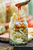 Bean and cucumber salad with onions and tomato sauce, in a jar