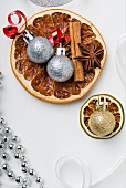 Dried fruit, cinnamon sticks, star anise and Christmas tree baubles