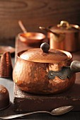 Assorted copper pots and cooking utensils