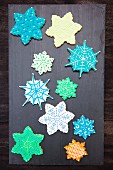 Snowflake Sugar Cookies hand decorated and displayed on a slate rock