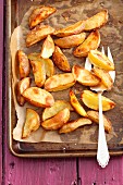 Baked potato wedges on the baking tray