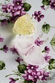 Heart-shaped ice cubes, one with elderflowers in the ice